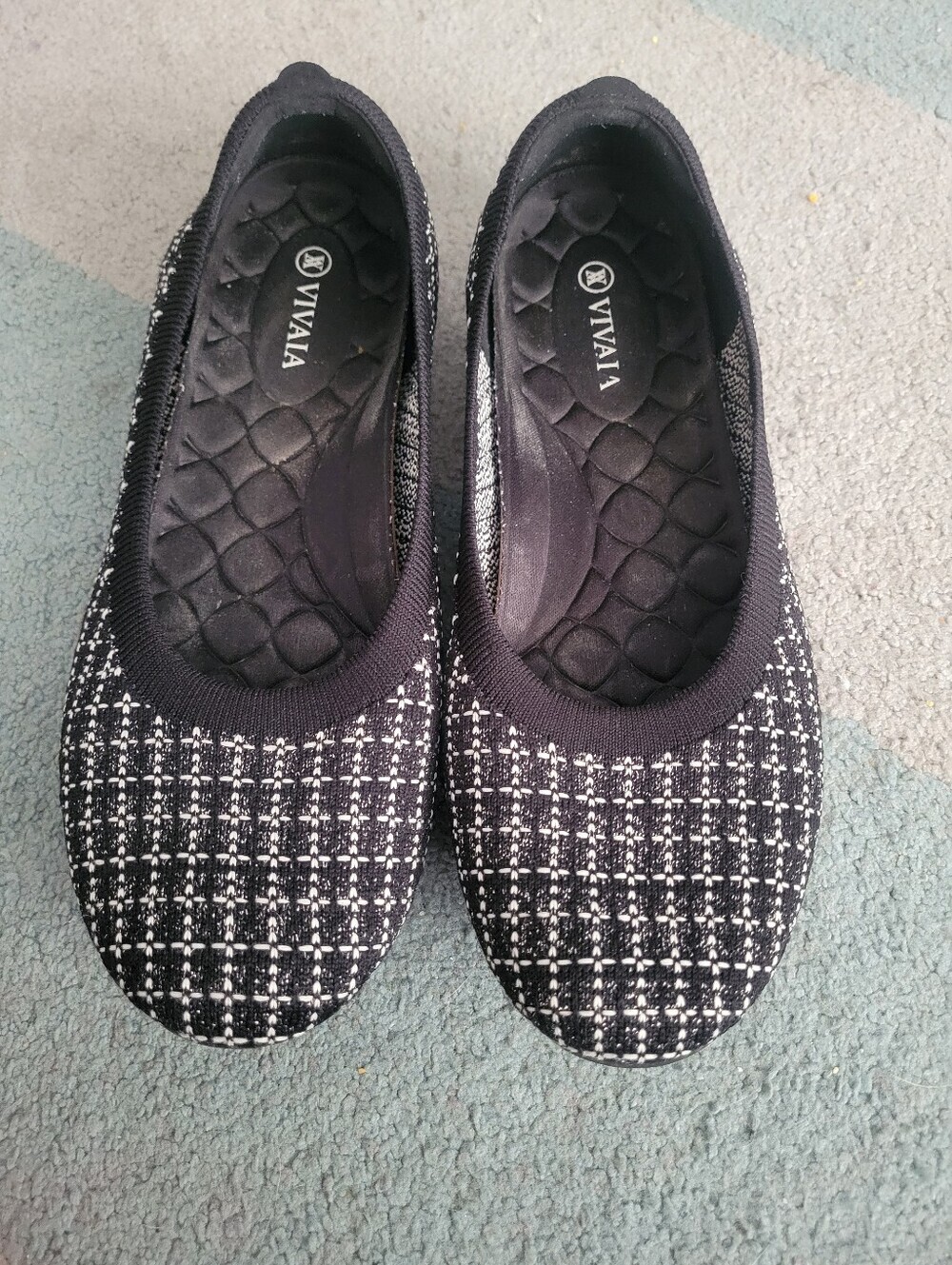 Vivaia flats in a black and white knit tweed pattern.